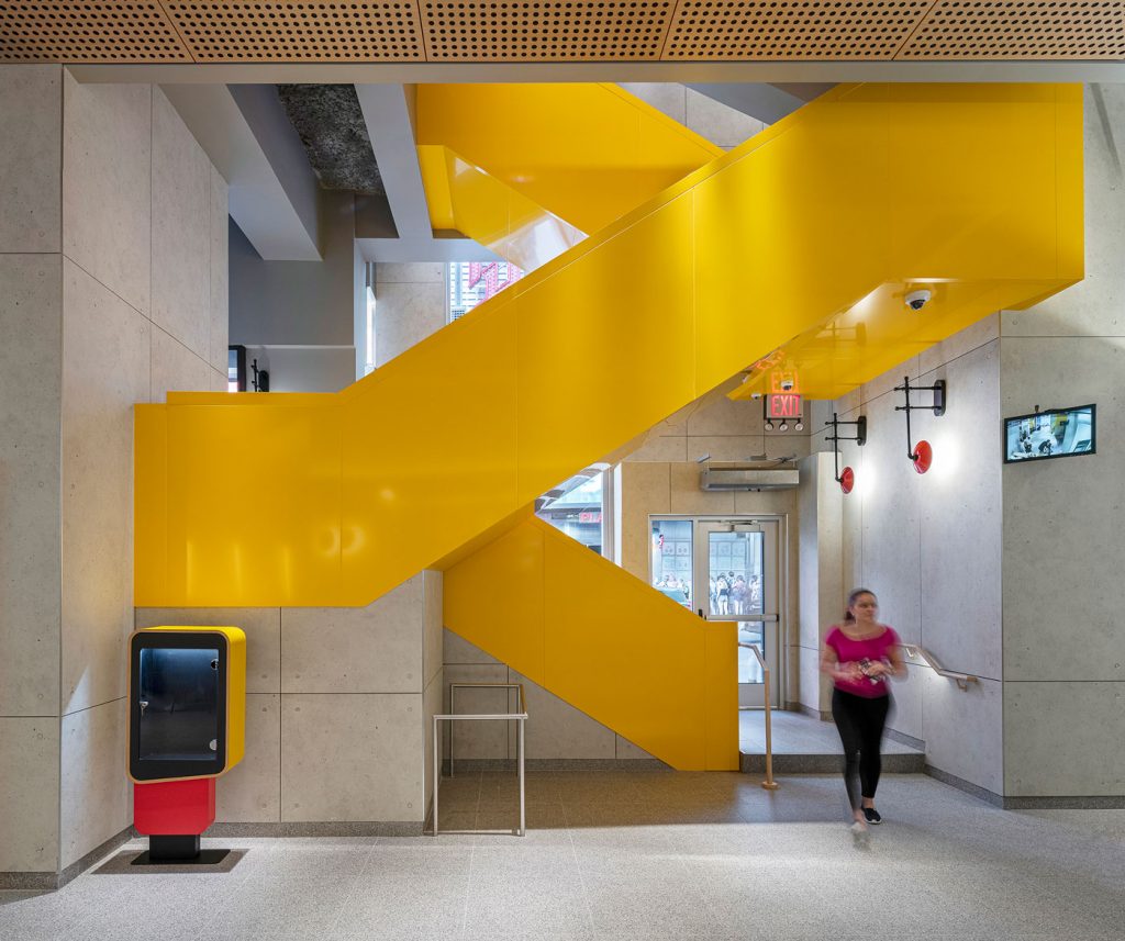 Interior of McDonalds featuring a bold yellow staircase.